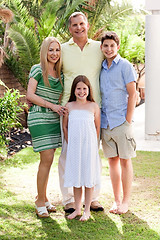 Image showing Happy family standing together in their backyard of home