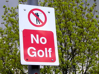 Image showing no golf sign against a tree