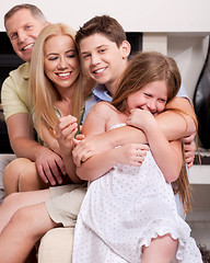 Image showing Happy family sitting in straight and having fun