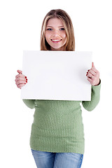 Image showing Smiling young beautiful girl  holding blank white board