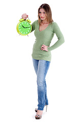 Image showing attractive young model  holding the clock