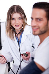 Image showing Patient checking his blood pressure