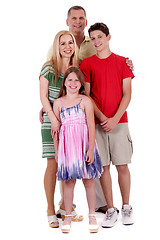 Image showing Happy family of four standind and looking at you