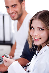 Image showing Female doctor checking blood pressure