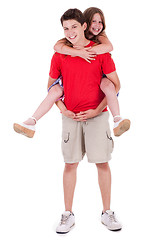 Image showing Loving brother gives piggyback to his beautiful sister