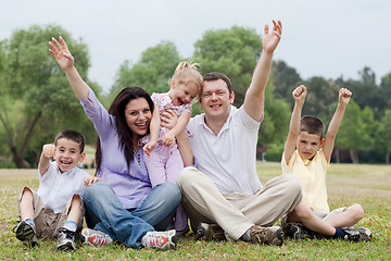 Image showing Happy family of five having fun by raising hands