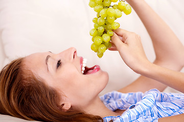 Image showing pretty girl with green grapes