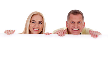 Image showing Man and woman holding empty white board