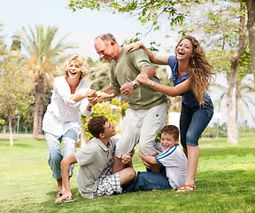 Image showing Family holding back grandfather and having fun