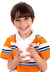 Image showing Young kid holding a glass of milk