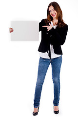 Image showing young lady pointing at blank board