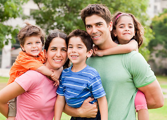 Image showing Caucasian parents piggyback their children