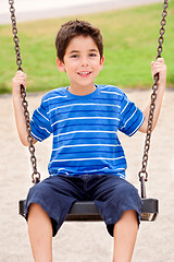 Image showing Young kid enjoying swing ride