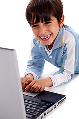 Image showing Cute smiling caucasian kid with laptop