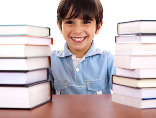 Image showing School boy surrounded by books