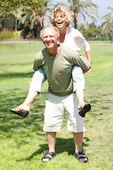 Image showing Old lady enjoying piggyride