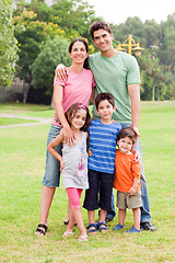Image showing Middle aged couple standing with their children
