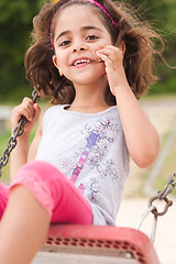 Image showing Lovely girl on a swing in the park