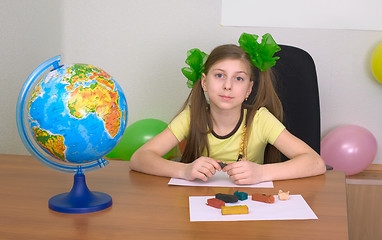 Image showing Girl sitting at a table with plasticine