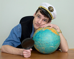 Image showing Man in uniform cap with globe