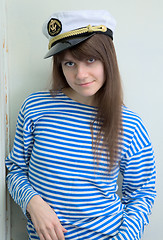 Image showing Girl in a cap and a stripped vest