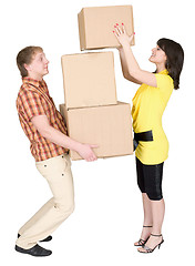Image showing Girl loads the man with cardboard boxes