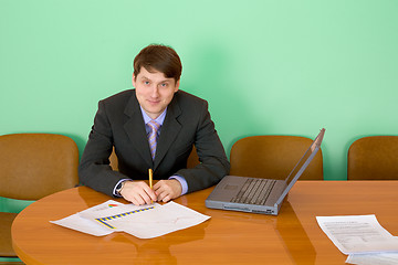 Image showing Businessman at a table with laptop