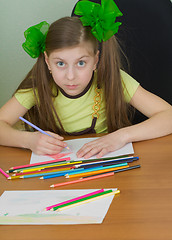 Image showing Girl drawing sitting at a table