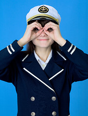 Image showing Girl in a sea uniform emits binoculars