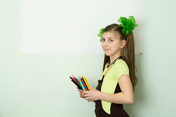 Image showing Girl with color pencils and a sheet of paper