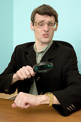 Image showing Person view a watch through a magnifier