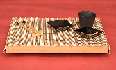 Image showing Still life from tray with chinese stick's and sauce-boat