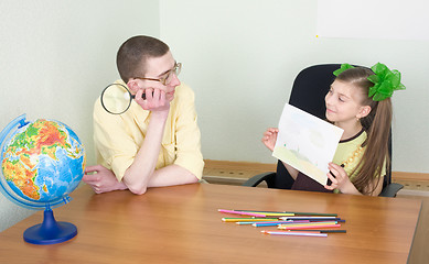 Image showing Girl shows new drawing to the brother