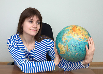 Image showing Woman in a stripped vest with globe