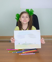 Image showing Smiling girl shows new drawing to us