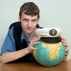 Image showing Man with the globe and a cap