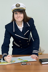 Image showing Woman in a sea uniform at table with map