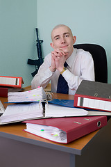 Image showing Self-satisfied worker of office armed with a rifle