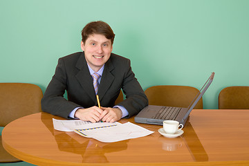 Image showing Businessman on a workplace with the laptop