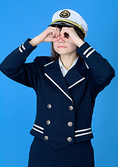 Image showing Girl in a sea uniform emits binoculars
