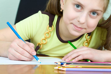 Image showing Girl holding a blue pencil