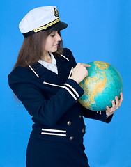 Image showing Woman in sea uniform and globe