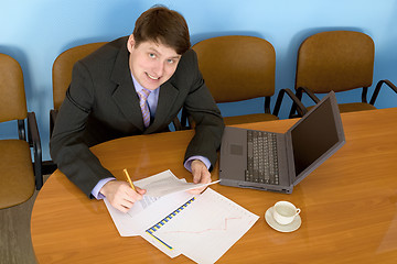 Image showing Businessman on a workplace with the laptop