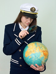 Image showing Girl in a sea uniform with the globe