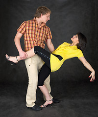 Image showing Couple dancing a tango on a black
