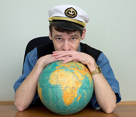 Image showing Man in uniform cap with globe