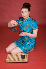 Image showing Japanese girl with teapot