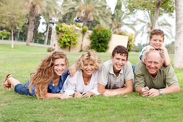 Image showing Affectionate family lying in the park