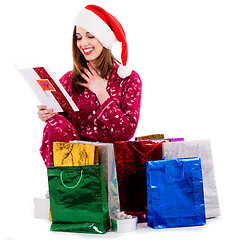 Image showing young lady with christmas card and gifts