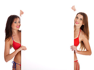 Image showing Girls in bikini holding a sign board